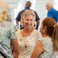 Group of three woman standing together and talking